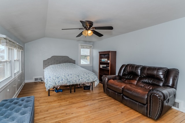 bedroom featuring light hardwood / wood-style floors, vaulted ceiling, and ceiling fan