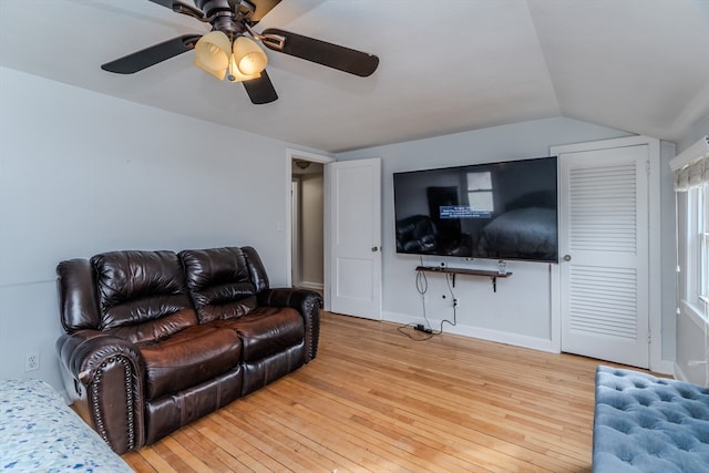 living room with ceiling fan, vaulted ceiling, and hardwood / wood-style flooring