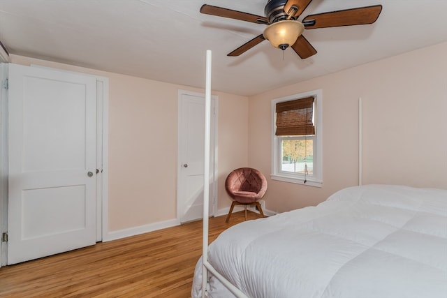 bedroom with light hardwood / wood-style floors and ceiling fan