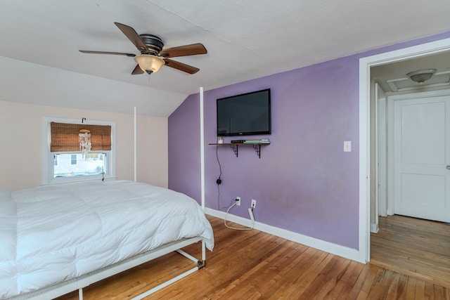 bedroom with hardwood / wood-style flooring, ceiling fan, and lofted ceiling