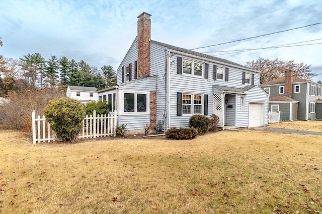 view of front of house with a garage and a front lawn