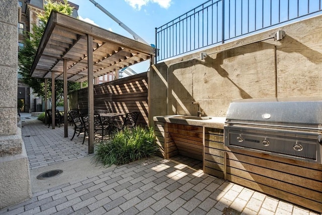 view of patio with grilling area, area for grilling, a pergola, and outdoor dining space