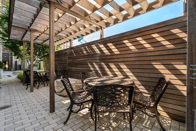 view of patio / terrace featuring a pergola and outdoor dining space