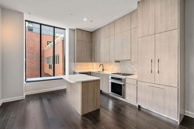 kitchen featuring tasteful backsplash, modern cabinets, dark wood-type flooring, stainless steel appliances, and light countertops