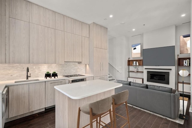 kitchen with dark wood-style floors, light brown cabinets, modern cabinets, and a sink