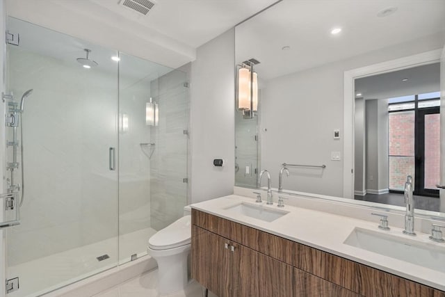 full bathroom with toilet, a shower stall, visible vents, and a sink