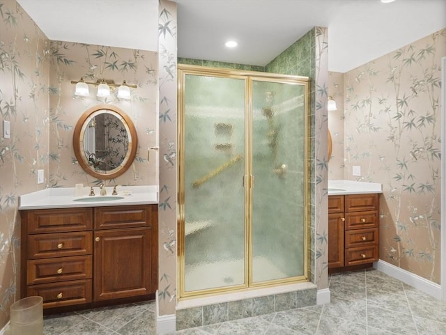 bathroom with tile patterned floors, vanity, a shower stall, and wallpapered walls