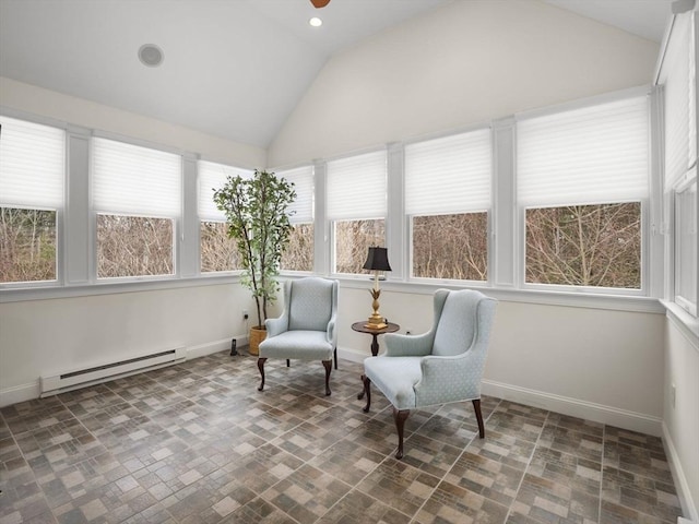 sunroom with a ceiling fan, a baseboard radiator, and vaulted ceiling