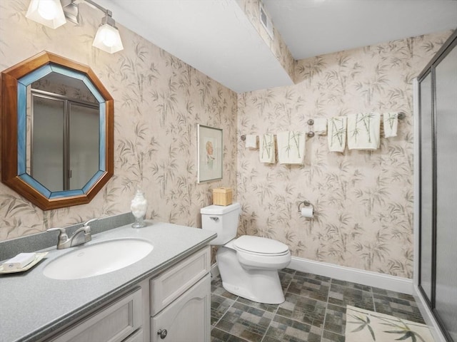 bathroom featuring toilet, wallpapered walls, baseboards, and vanity