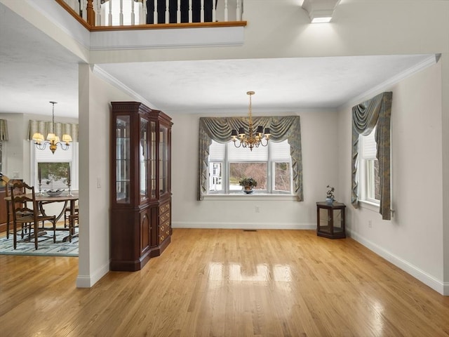 dining area featuring a chandelier, plenty of natural light, and light wood finished floors