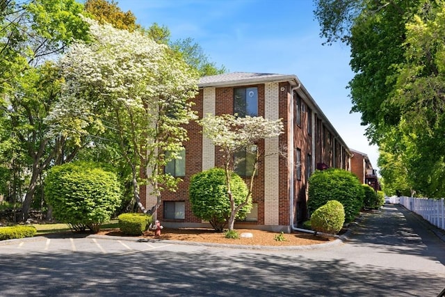 view of side of home with brick siding