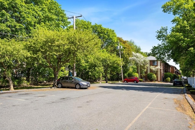 view of asphalt street featuring curbs