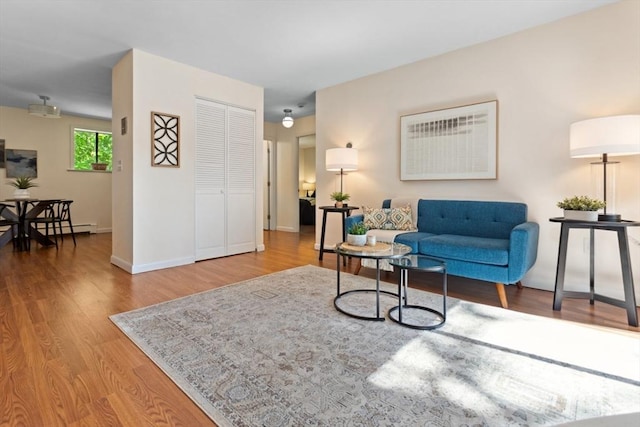 living area with wood finished floors and baseboards