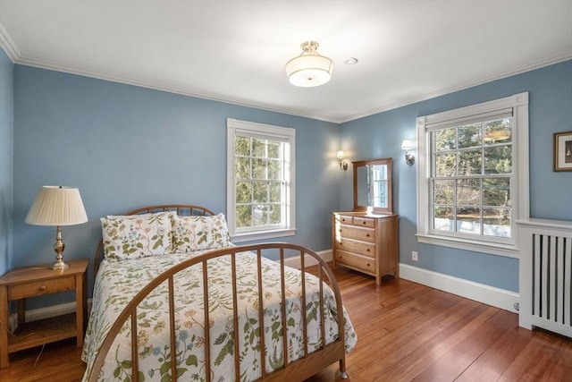 bedroom featuring crown molding and dark hardwood / wood-style floors