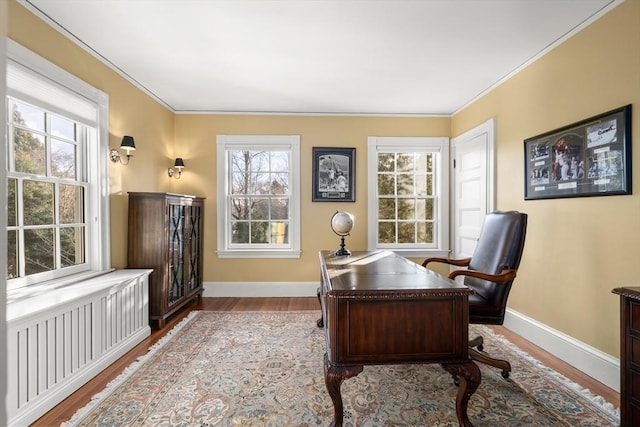 office area with crown molding and light hardwood / wood-style floors