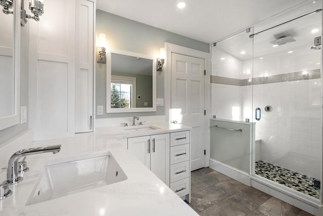 bathroom featuring vanity and an enclosed shower