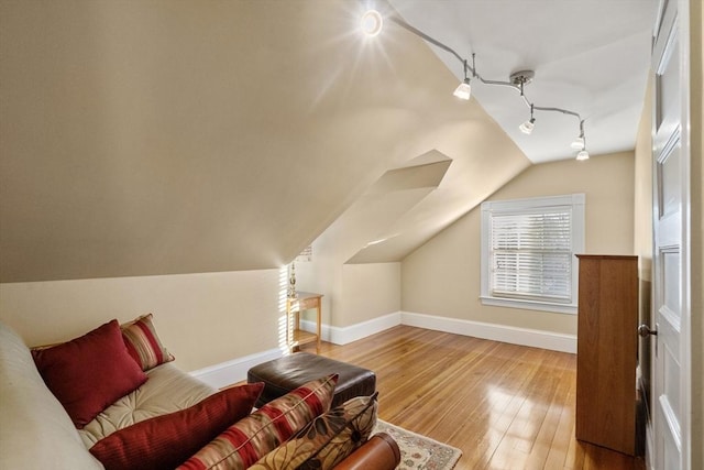 additional living space featuring lofted ceiling and hardwood / wood-style flooring