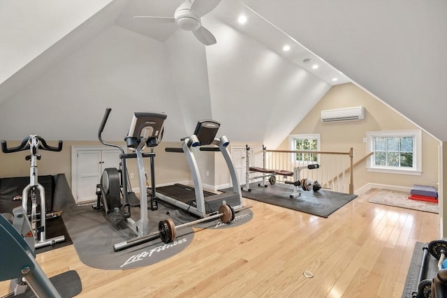 exercise room featuring ceiling fan, hardwood / wood-style flooring, vaulted ceiling, and a wall mounted AC