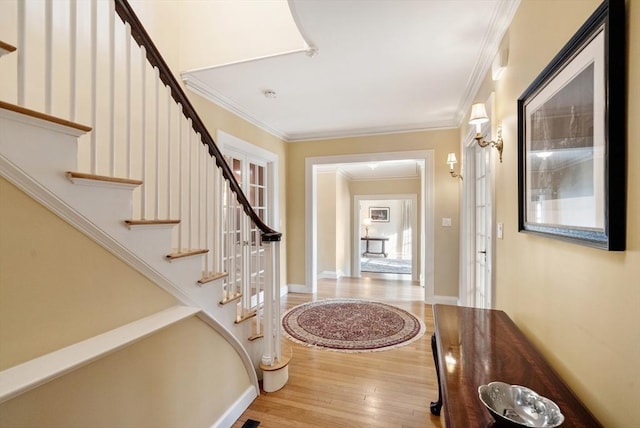 foyer entrance featuring crown molding and wood-type flooring