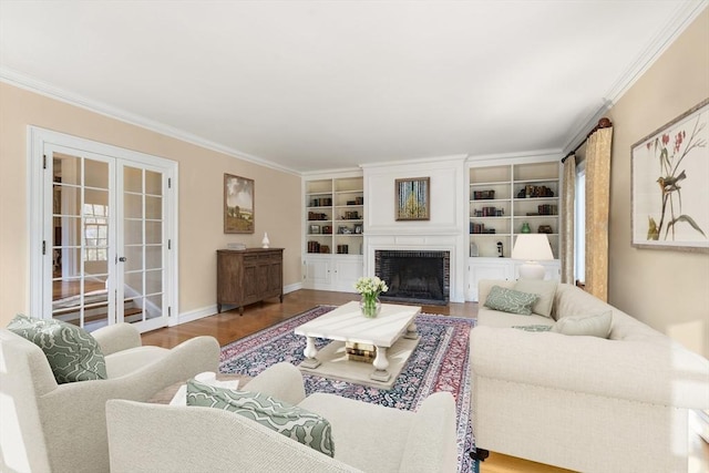 living room featuring french doors, ornamental molding, a fireplace, and wood-type flooring