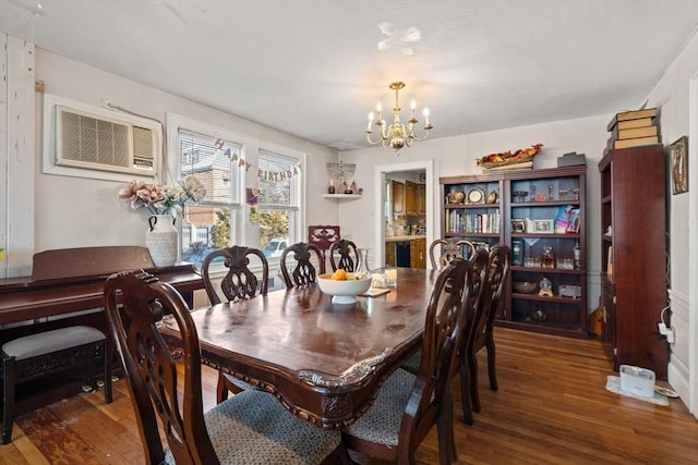 dining area featuring dark wood-type flooring, a wall mounted air conditioner, and an inviting chandelier