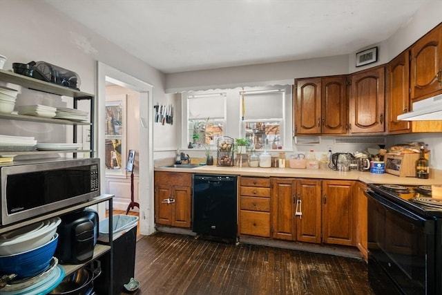 kitchen with dark hardwood / wood-style flooring, sink, and black appliances