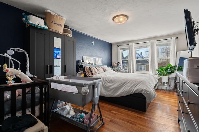 bedroom featuring hardwood / wood-style flooring and a textured ceiling