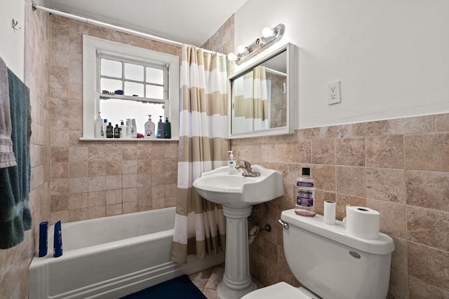 bathroom featuring toilet, tile walls, and shower / bath combo