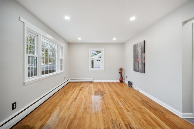 spare room with light hardwood / wood-style floors and a baseboard radiator