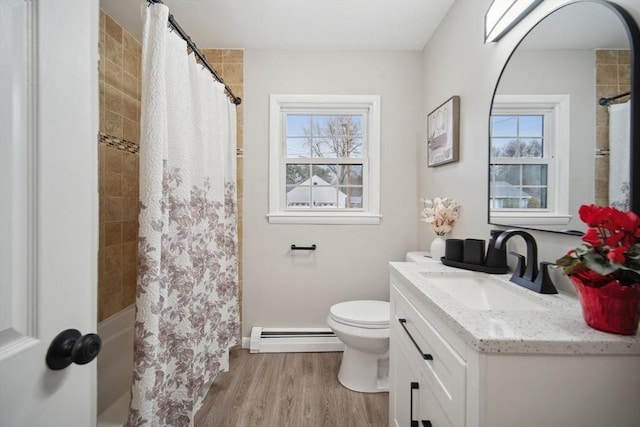 bathroom featuring toilet, vanity, a baseboard radiator, and wood-type flooring