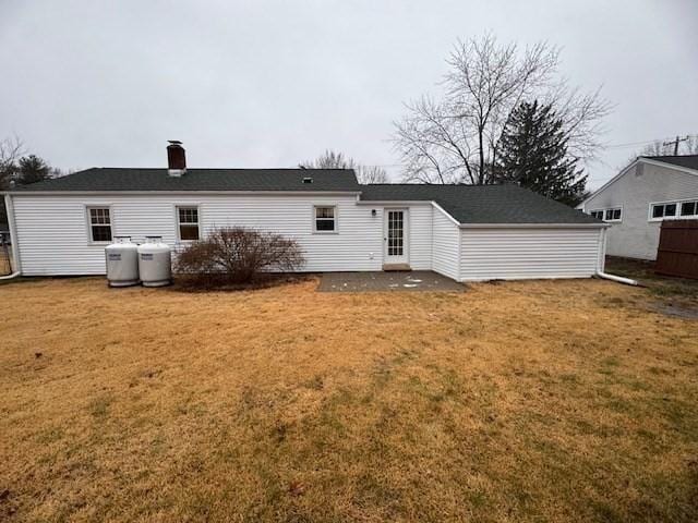 rear view of house with a lawn