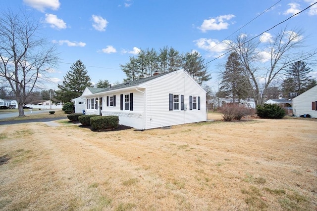 view of side of home featuring a yard