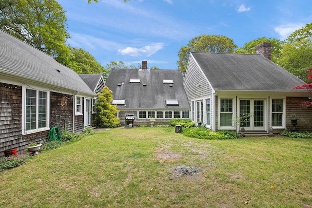 181 Pleasant St, Yarmouth, MA 02664 - back of property featuring a chimney, french doors, a lawn, and a shingled roof