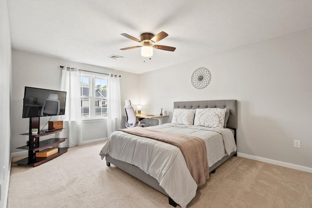 bedroom with light colored carpet, baseboards, and ceiling fan