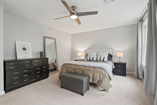 bedroom with light carpet, ceiling fan, and baseboards