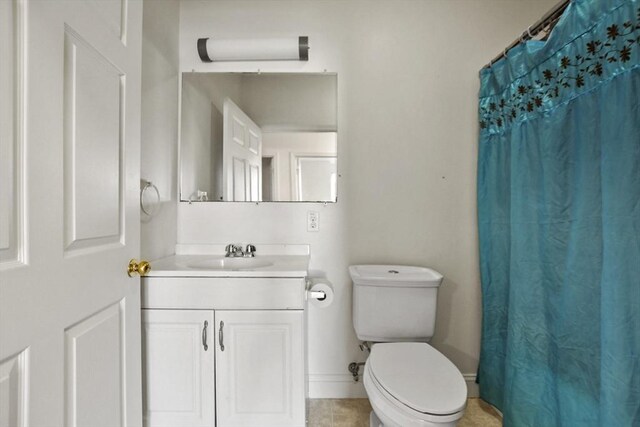 bathroom featuring vanity, tile patterned flooring, toilet, a shower with shower curtain, and baseboards