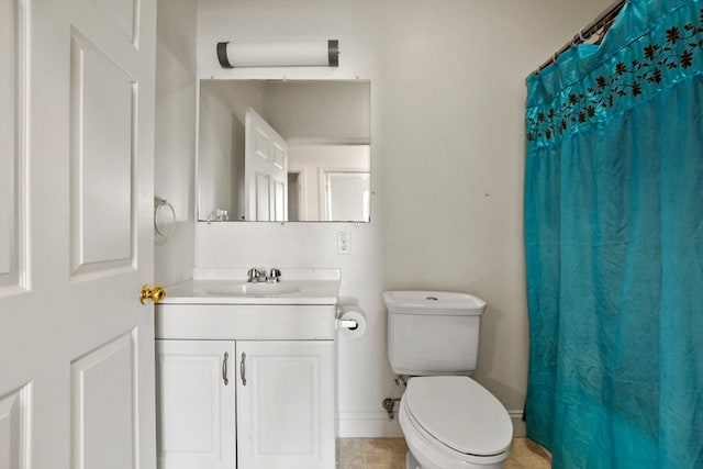 bathroom with curtained shower, vanity, toilet, and tile patterned floors