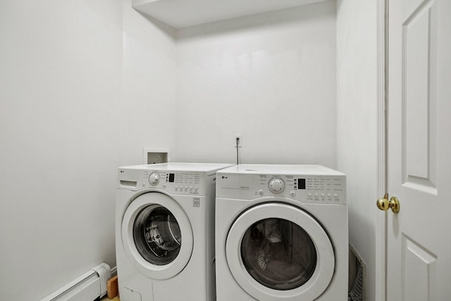 laundry room with baseboard heating and washer and dryer