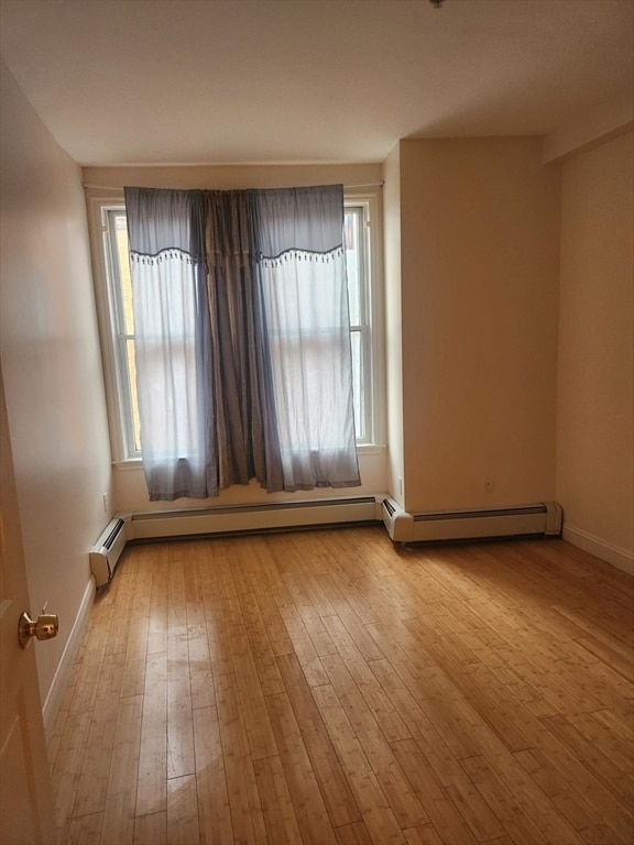 empty room with light hardwood / wood-style flooring