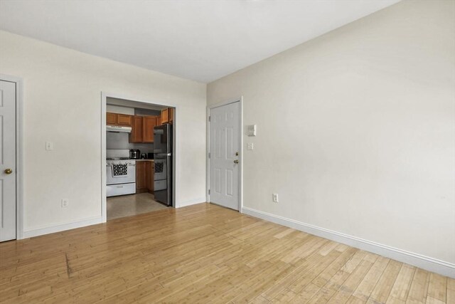 unfurnished living room featuring light wood-type flooring and baseboards