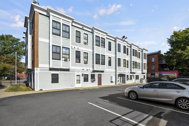 view of building exterior featuring uncovered parking