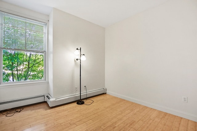 spare room with light hardwood / wood-style floors and a wealth of natural light