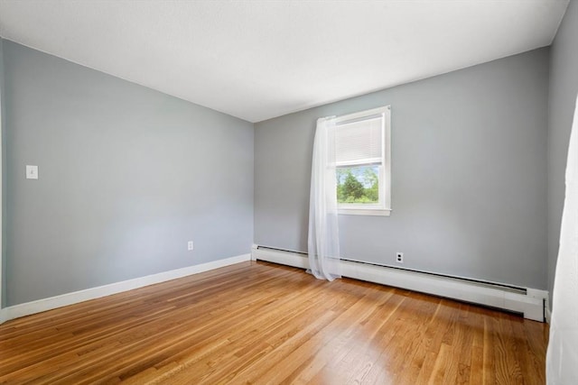 21 Wilhelmina Ave, Burlington, MA 01803 - empty room featuring light wood-type flooring, baseboards, and a baseboard radiator