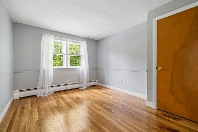 21 Wilhelmina Ave, Burlington, MA 01803 - spare room with hardwood / wood-style flooring, baseboards, baseboard heating, and a textured ceiling