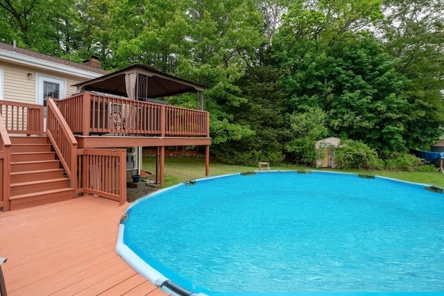 21 Wilhelmina Ave, Burlington, MA 01803 - outdoor pool with a deck, stairway, and view of wooded area