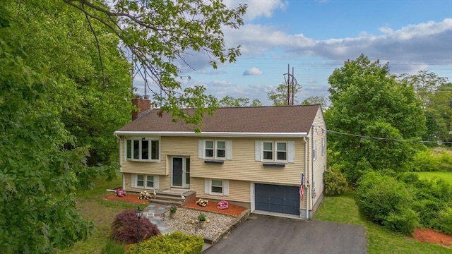 21 Wilhelmina Ave, Burlington, MA 01803 - split foyer home with a chimney, a garage, and driveway