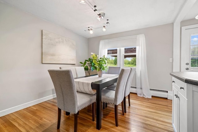 21 Wilhelmina Ave, Burlington, MA 01803 - dining room with light wood finished floors, baseboard heating, and baseboards