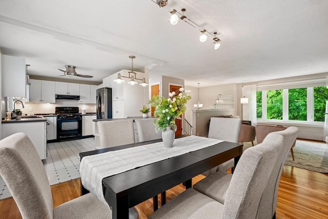 21 Wilhelmina Ave, Burlington, MA 01803 - dining space featuring light wood-style flooring, a ceiling fan, and a chandelier
