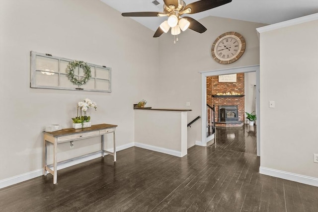 hall featuring baseboards, wood finished floors, and high vaulted ceiling