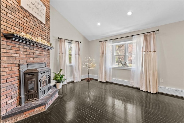 unfurnished living room with a wood stove, baseboards, wood finished floors, baseboard heating, and recessed lighting